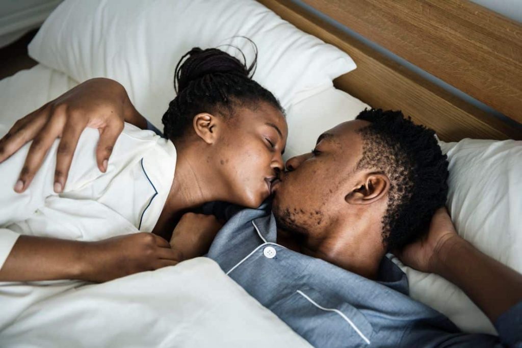 black couple from blackpeople meet is kissing on a bed