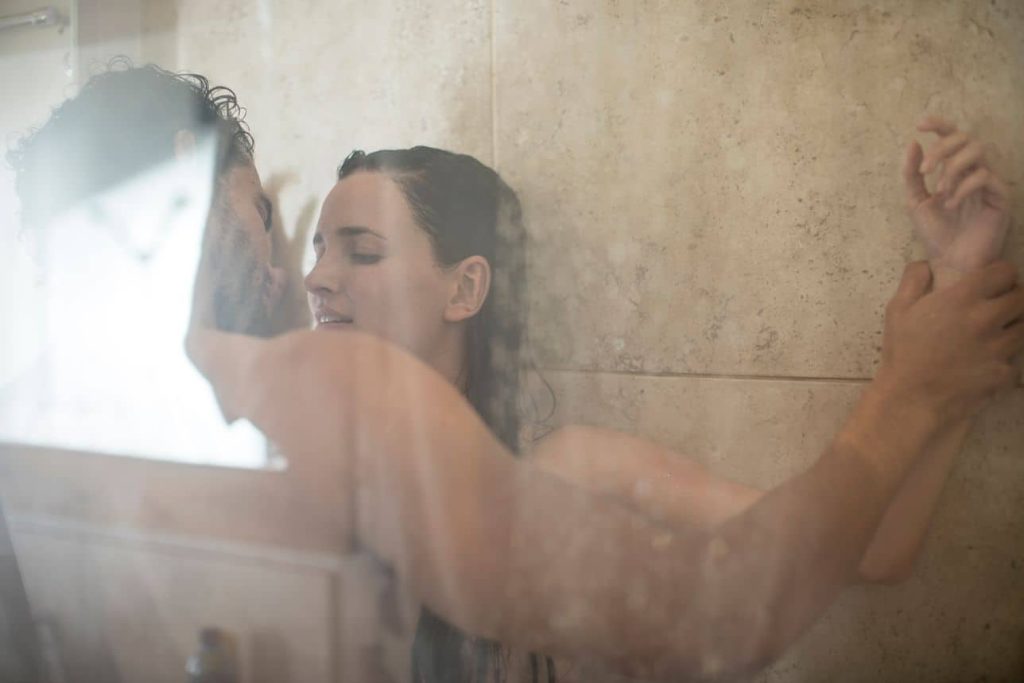 a woman and man member from nudistfriends are having showers together