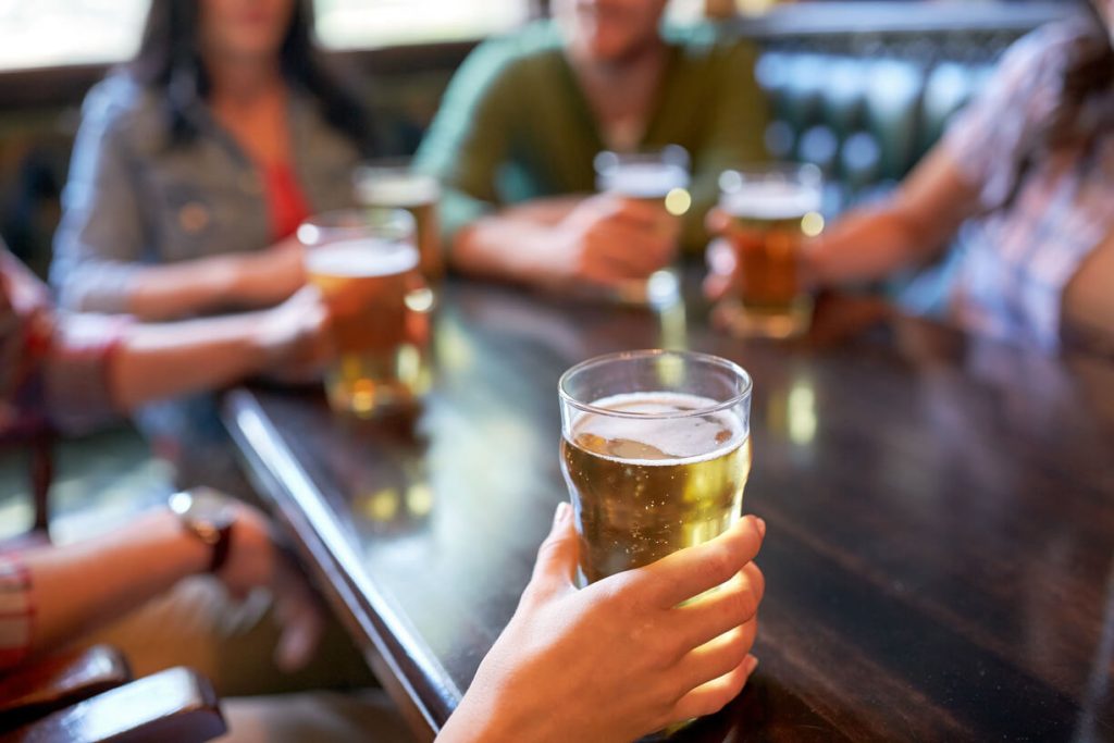 a group of milf from washington dc is drinking some beer in a bar