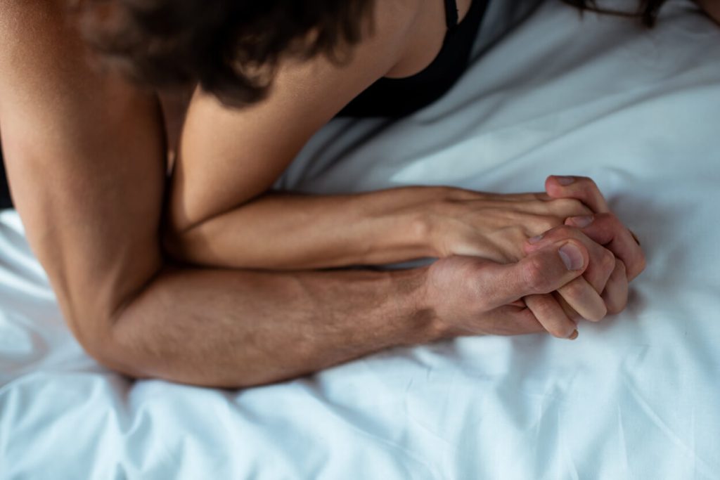 a man hold tight the hand of a mature woman from san antonio while they are on a bed and kiny
