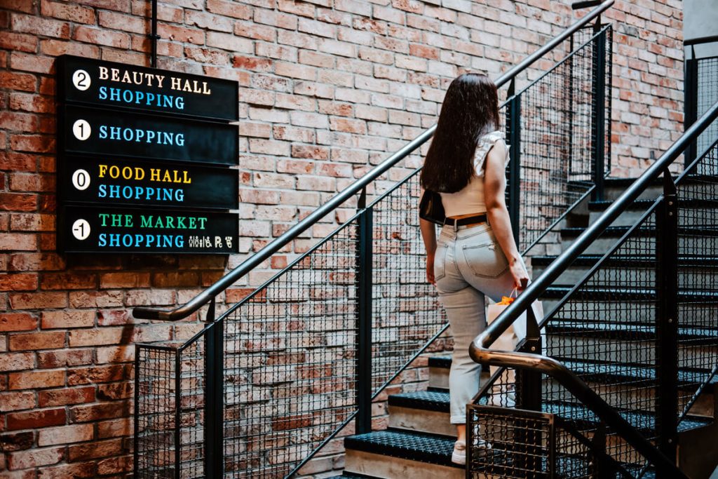 a cougar from san jose is walking on the stairs and going to the shopping mall