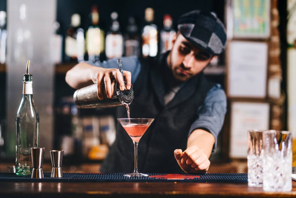a bartender mixing up a drink in a bar in philadelphia