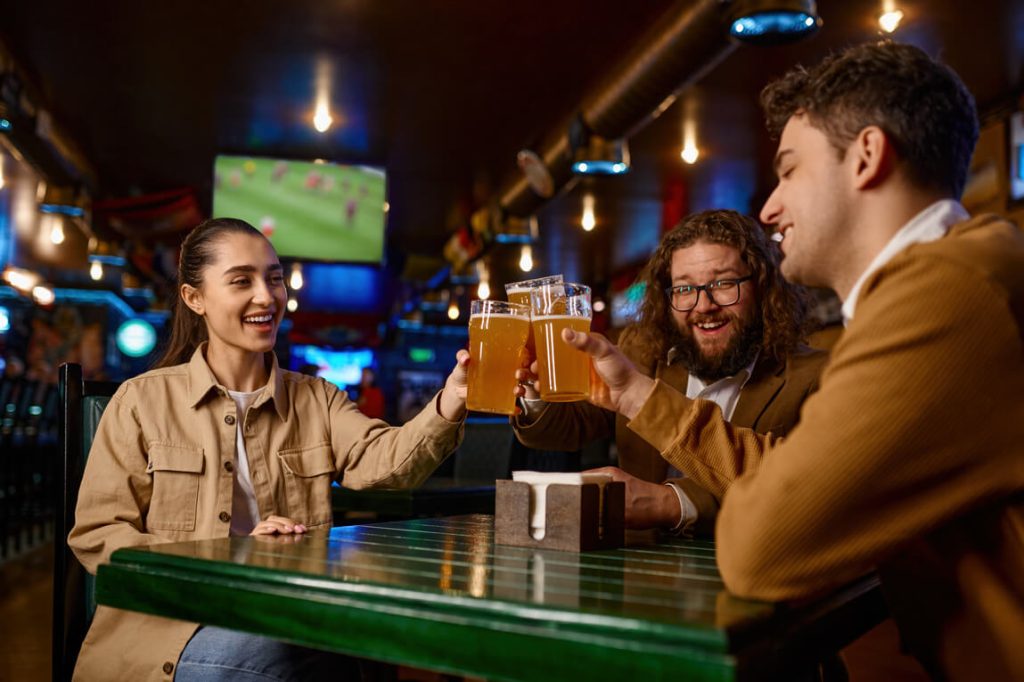people drinking beer at bar in houston before hooking up